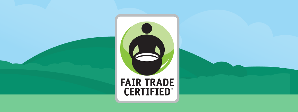 Fair Trade CertifiedTM logo in front of green hills